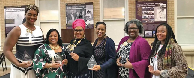 Six African American women hold awards and smile